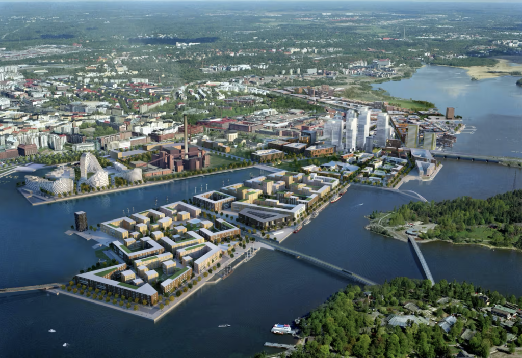 Vue aérienne d'un quartier durable mêlant logements, bureaux, espaces publics et infrastructures au bord de l'eau.